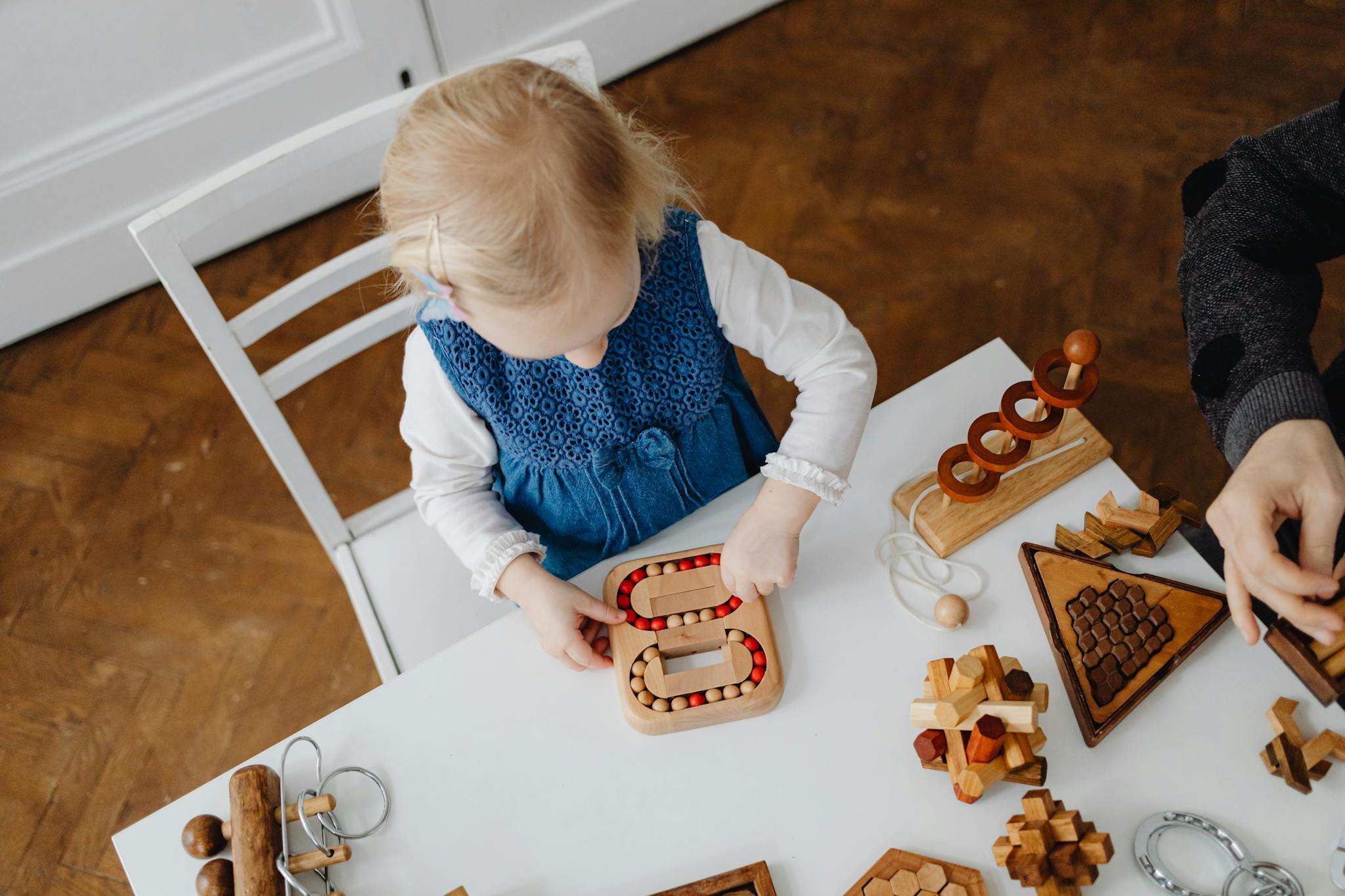 A child playing with wooden puzzles at home, fostering creativity and learning.