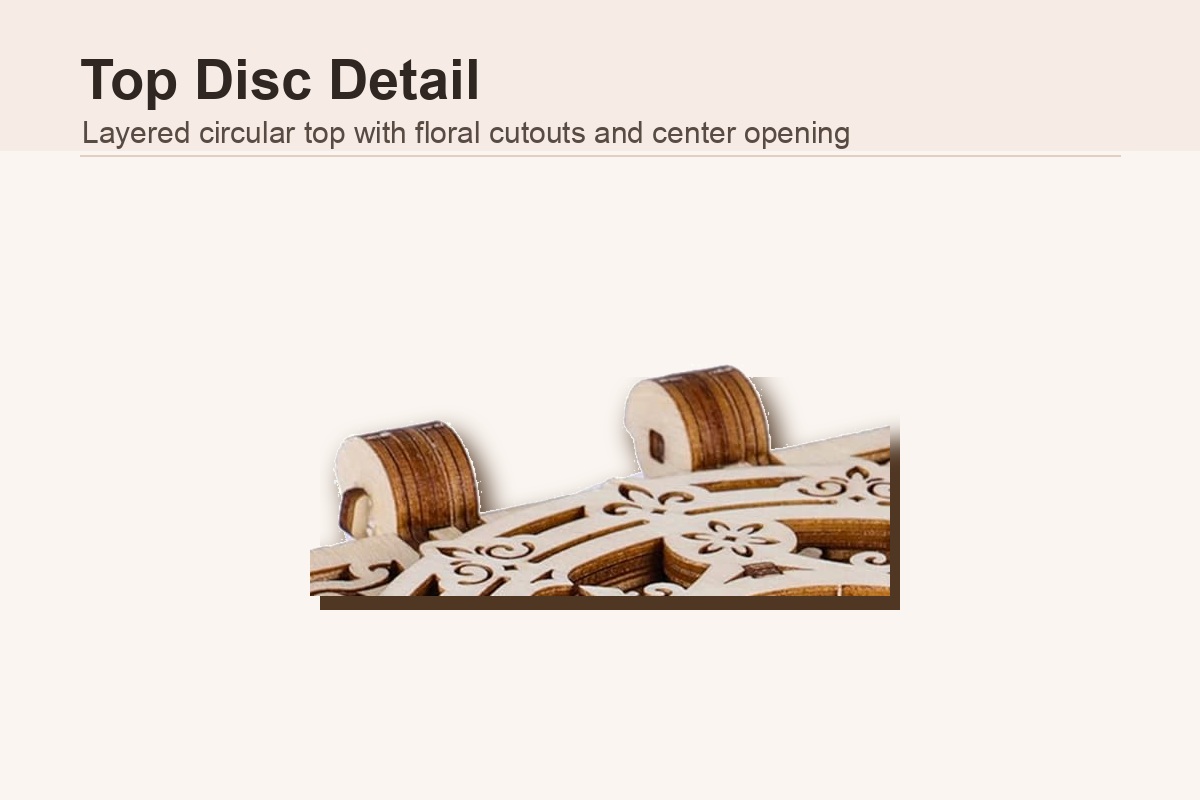 Mechanical music box top disc detail with layered circular cutouts and center opening
