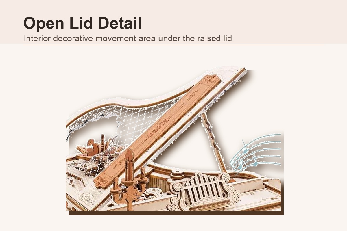 Open lid detail of piano model music box showing decorative movement area